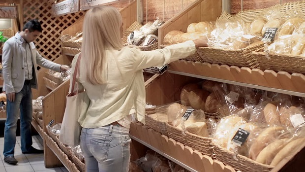 customer picking bread from stores